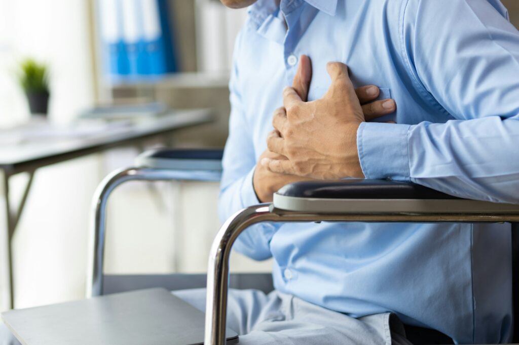 A man in a wheelchair has chronic chest pain, heart attack.