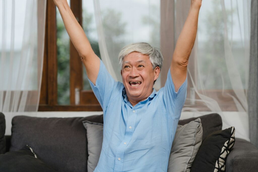 Asian senior men play games at home.